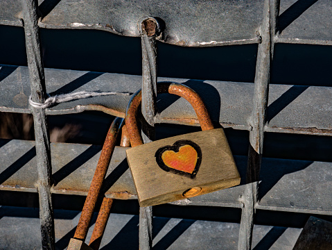 Old locks of loving couples hang on the bridge