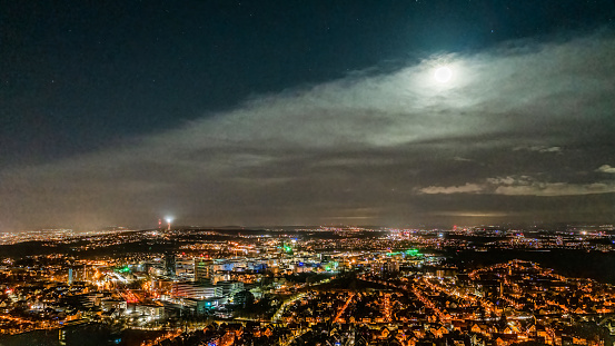 Stuttgart Night Skyline Panorama with Moon and Clouds - Urban Germany at Night.
