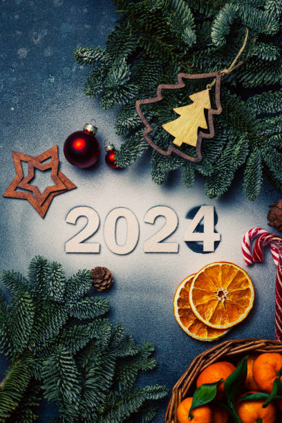 istock The numbers 2024 are on artificial snow, next to branches and toys 1899343367