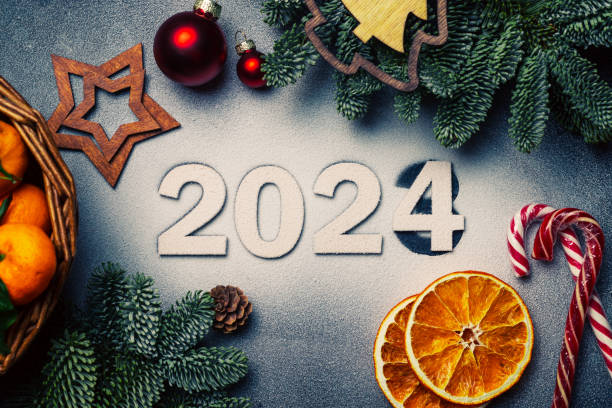 istock The numbers 2024 are on artificial snow, next to branches and toys 1899343415