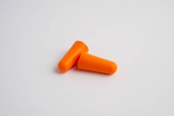 istock Pair of orange earplugs on a white background 1899350812