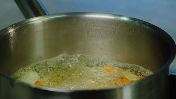 istock Vegetables start boiling in pot in kitchen closeup 1899351331
