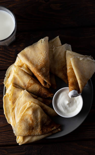 istock pancakes rolled up into tubes lie on a slide 1899355437