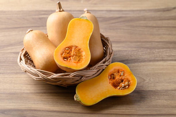 istock Butternut squash pumpkin in basket on wooden background 1899365422