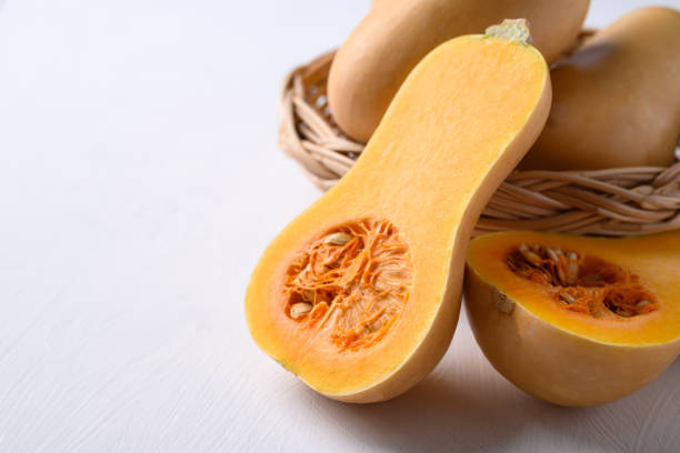 istock Half butternut squash pumpkin in basket on white background 1899367033