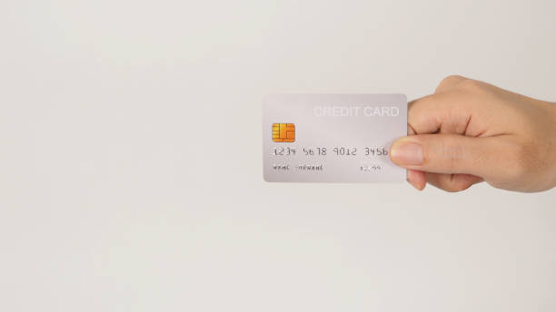 istock Hand is holding a silver credit card isolated on white background. 1899385223