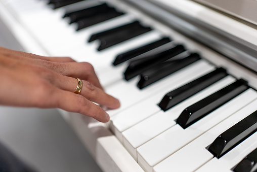 hand of a woman playing the piano