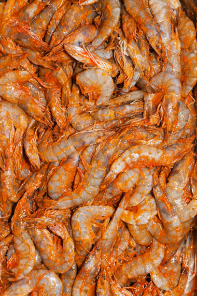 istock Raw shrimp in tomato sauce, close-up. 1899410877