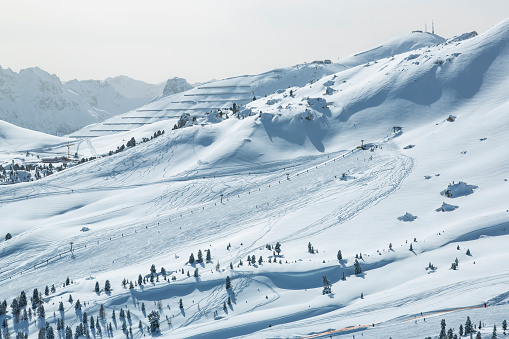 Skiers skiing at winter ski resort near Grohmannspitze, Sella pass, Sella Ronda, Dolomites, Italy.