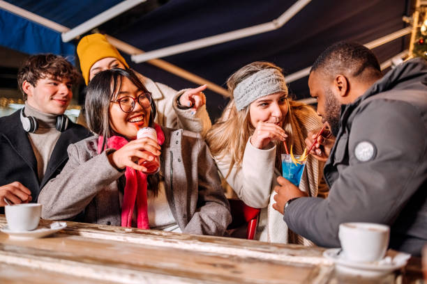 istock Group of people having fun together at cafe bar outside at night 1899456549