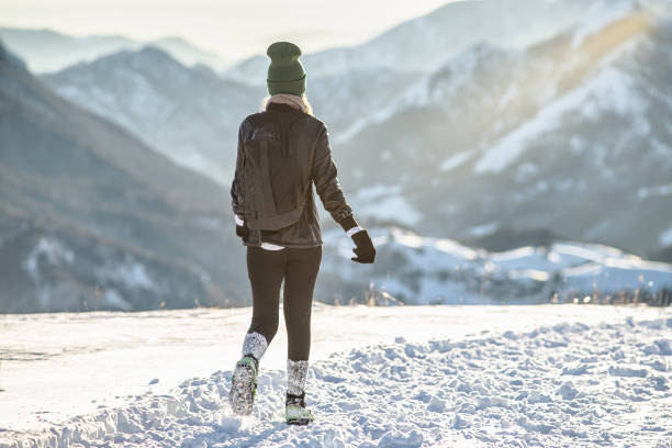 istock Young woman steps on the snow 1899483562