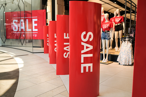 Advertising Sales On Store Display In Shopping Center Captivates Many Shoppers