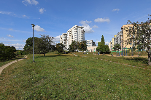 Warsaw, Poland - September 24, 2023: Residential buildings, a large empty square and nature, seen as part of the Goclaw housing estate in the Praga-Poludnie district.