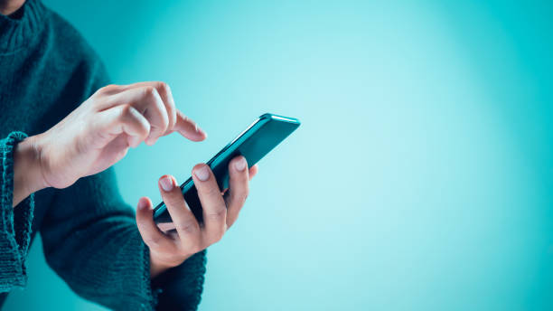 istock Website page, contact us or email marketing concept, customer support hotline, contact us. Human uses smartphone on blank background. Email, phone, address, chat message icon. 1899508076