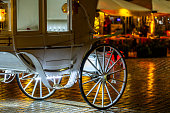 The wheel of a white carriage carrying tourists around the Old Town Square in Cracow.