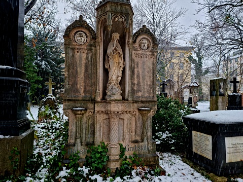 The Alter Südfriedhof (Old South Cemetery) is a cemetery in Munich, Germany. It was founded by Duke Albrecht V as a plague cemetery in 1563. The image shows a main avenue capture don a snowy day during winter season.