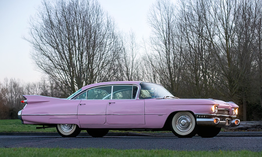 Stony Stratford,UK Jan 1st 2024  A 1959 pink Cadillac arriving at Stony Stratford for the annual New Years Day vintage and classic vehicle festival.