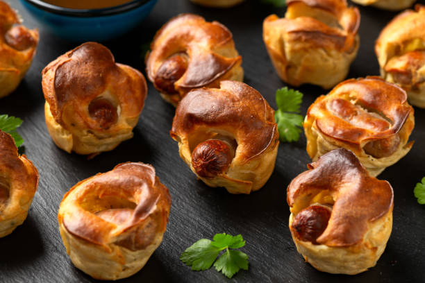 istock Mini Toad in the hole, Baked sausages in Yorkshire pudding with gravy 1899560271