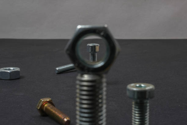 Metal bolts and nuts of different sizes on the table