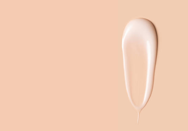 istock cosmetic smear texture on pastel beige background 1899607984