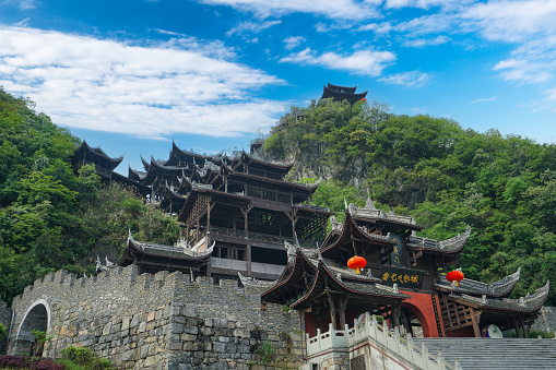 The brown and black stilted buildings are built according to the mountain. Chiyou Jiuli City integrates Miao culture and architecture. Chongqing, China.