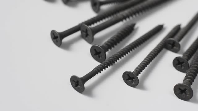 metal screws used in building isolated on gray background