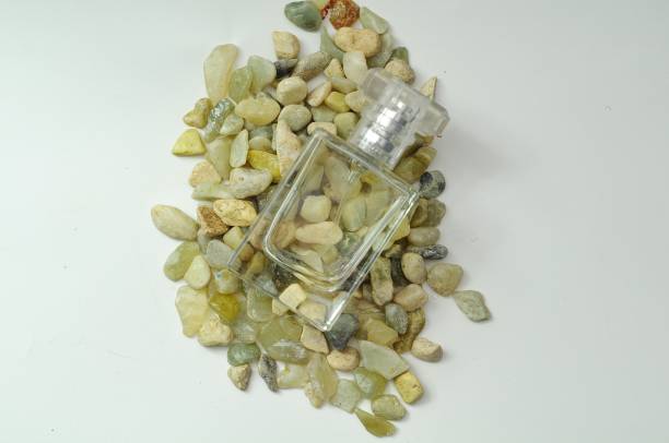 istock bottle of perfume from glass on small stone 1899676359