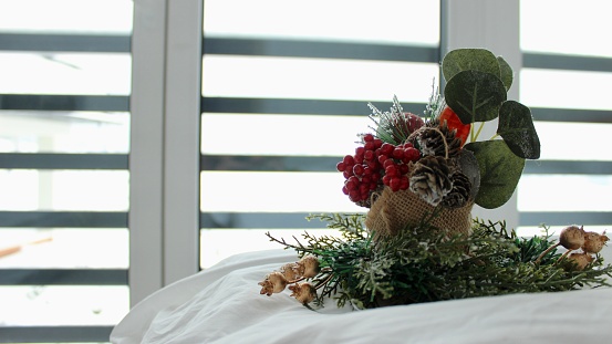 decorative composition on a snow-white bed against the background of a window overlooking a mountain landscape in winter.