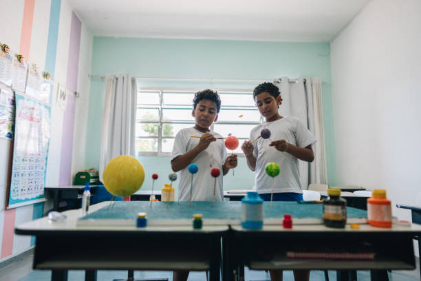 Students making a system solar model project on classroom at school