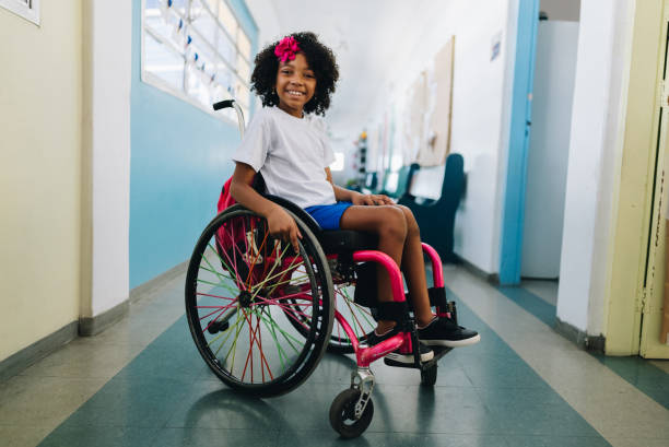 Portrait of a wheelchair girl student at school Portrait of a girl student using wheelchair at school wheelchair stock pictures, royalty-free photos & images