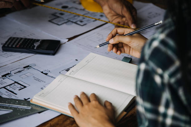 istock Construction and structure concept of Engineer or architect meeting for project working with partner and engineering tools on model building and blueprint in working site, contract for both companies. 1899723682