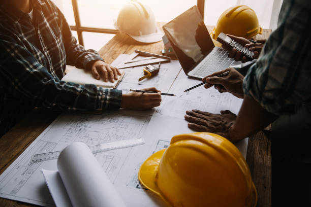 istock Construction and structure concept of Engineer or architect meeting for project working with partner and engineering tools on model building and blueprint in working site, contract for both companies. 1899723683