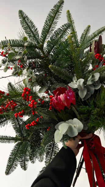 Seasonal Splendor: Woman Embracing Festive Bouquet