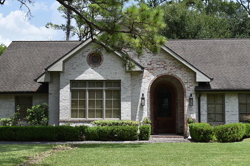 Houston, TX USA 07-27-2023 - A luxury home with a professionally landscaped garden and a quite welcoming front entrance in Houston Texas
