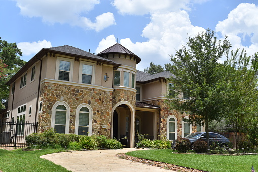 Houston, TX USA 07-27-2023 -  A luxury mansion, landscaped garden and front entrance in Houston Texas
