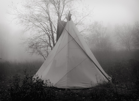 wigwam in a foggy forest, black and white photo