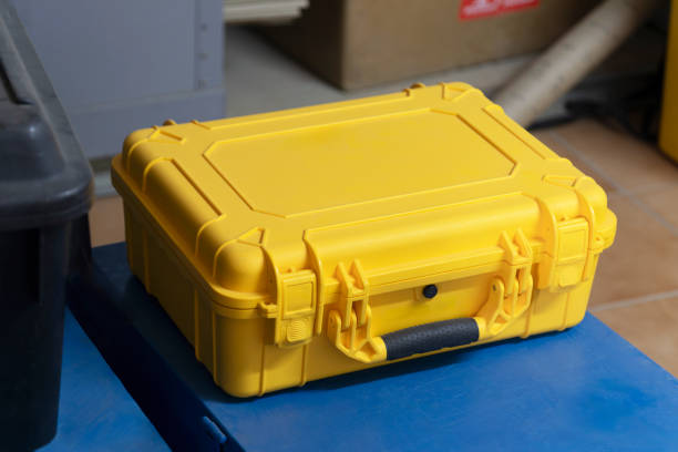 waterproof hardcase in a warehouse, sited on other metallic boxes ready for transport