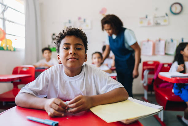 istock Portrait of a boy student studying on classroom at school 1899819703