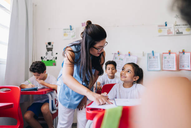 istock Teacher teaching her student on classroom at school 1899823409