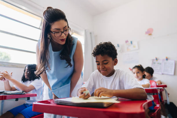 istock Teacher teaching her student on classroom at school 1899823419