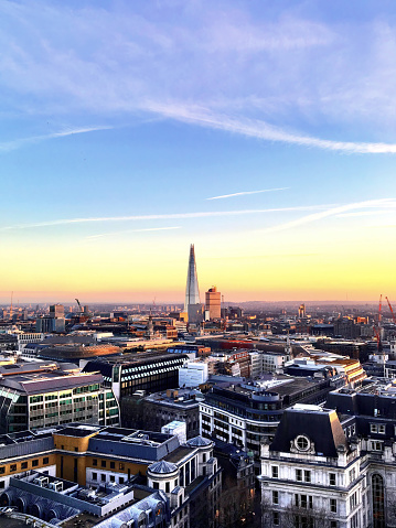 A vertical view of the London skyline at sunset.
