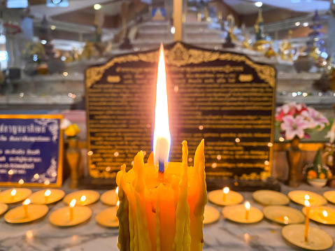 Candle burning in the temple of Thailand with concept religious of people washing.