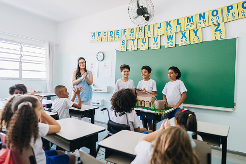 Students doing a presentation on classroom at school