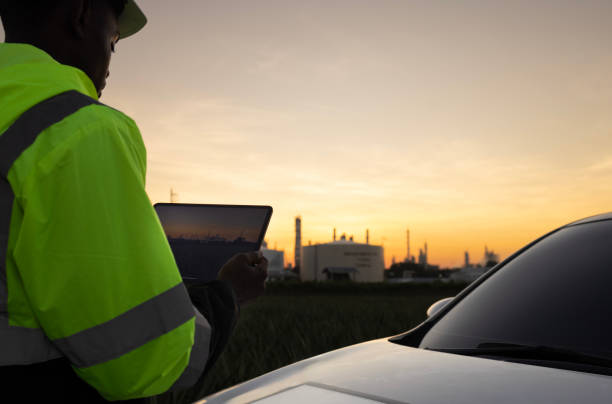 istock Site Engineer with green safety jacket and white safety hard hat working at front vehicle at outdoor 1899845293