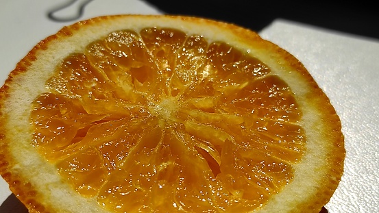 Close up of cut orange with sunlight