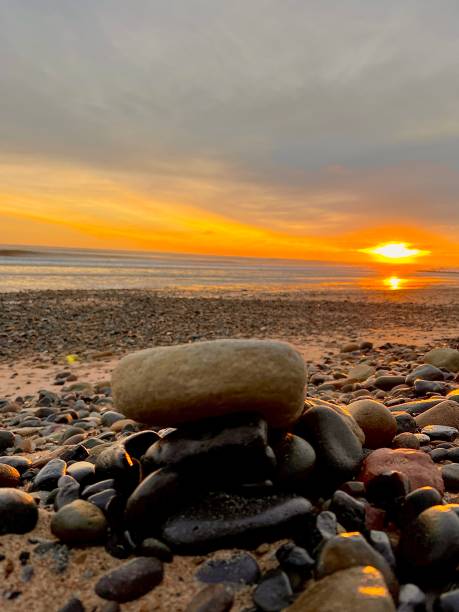 istock Sunrise over pebbles on Blyth Beach in Northumberland 1899849906
