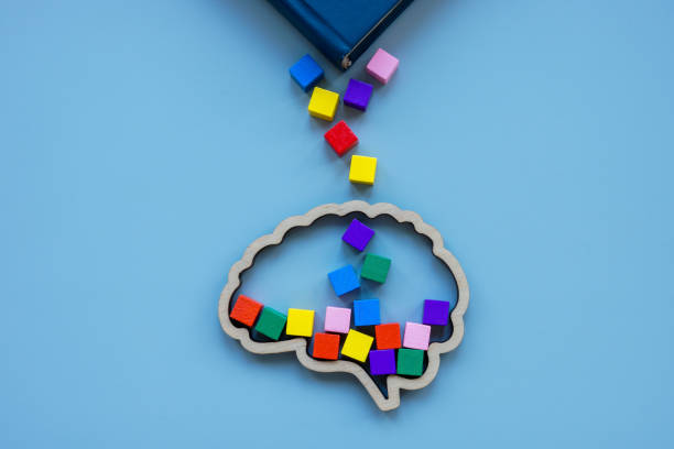 istock Knowledge and new ideas concept. Multi-colored cubes fall from the book into the brain. 1899889265
