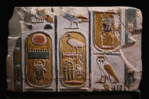 Luxor, Egypt - January 2, 2024: Ancient colorful relief and artifact with hieroglyphics in Luxor Museum