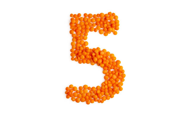 The digit '5' (five) formed from red lentil grains against a clean white backdrop. A harmonious blend of organic elements and typography, it captures the essence of eco-friendly, vegetarian artistry. Perfect for a food blog and menu