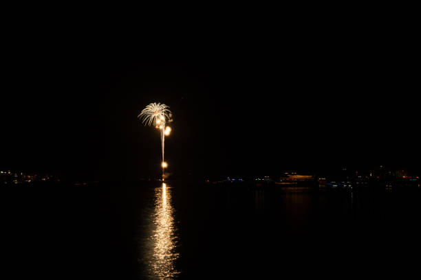 New Year's Eve fireworks over the channel in Marina del Rey, CA celebrate east coast midnight.